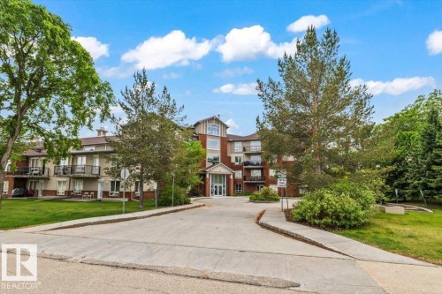 Four-story multi-unit residential building featuring brick and siding exterior - 116 6315 135 Avenue, Edmonton, AB 
