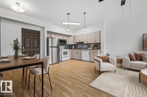 Open-concept living space with wood-finish flooring - 116 6315 135 Avenue, Edmonton, AB 