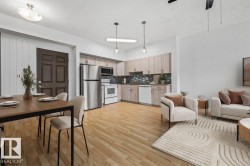 Open-concept living space with wood-finish flooring - 