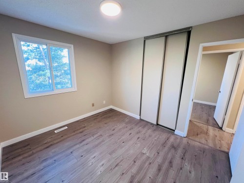 Interior room featuring wood-finish flooring and neutral wall tones - 2544 79 Street, Edmonton, AB - Indoor Photo Showing Other Room