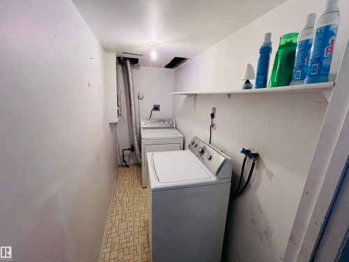 Dedicated laundry area featuring a top-load washing machine and a front-load dryer - 2544 79 Street, Edmonton, AB - Indoor Photo Showing Laundry Room