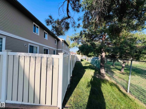 Exterior property featuring horizontal siding and multiple windows - 2544 79 Street, Edmonton, AB - Outdoor