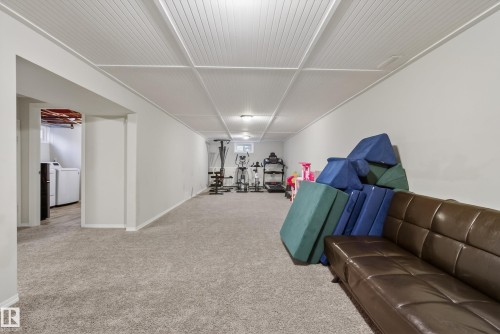 Spacious finished lower level featuring wall-to-wall carpeting and a drop ceiling with recessed lighting - 16105 109A Avenue, Edmonton, AB 