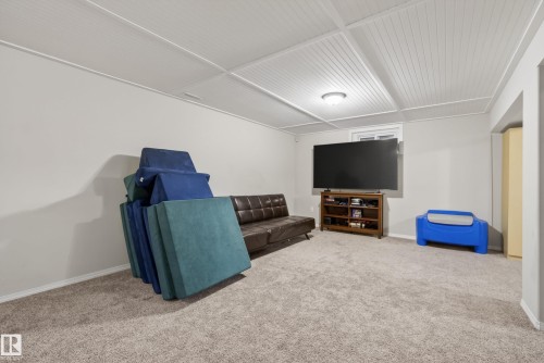 Carpeted flooring, light grey walls, and a white beadboard ceiling with recessed lighting - 16105 109A Avenue, Edmonton, AB 