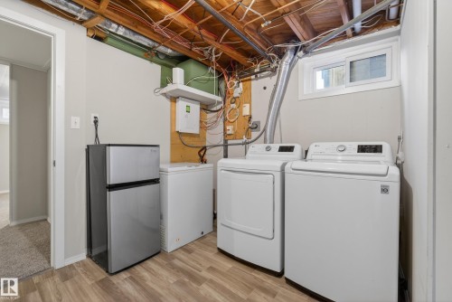 Utility area featuring wood-finish flooring and a ceiling with exposed joists - 16105 109A Avenue, Edmonton, AB 
