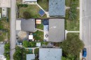 Spacious property featuring two structures with asphalt shingle roofing, a gravel driveway, and concrete walkways - 16105 109A Avenue, Edmonton, AB 