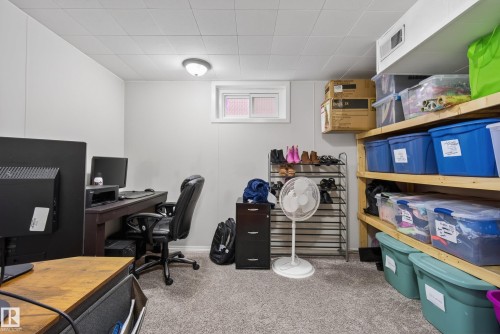 Finished room featuring light gray walls, plush gray carpeting, a drop ceiling, and a small window for natural light - 16105 109A Avenue, Edmonton, AB 