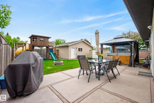 Spacious concrete patio featuring defined sections and direct access to the interior - 16105 109A Avenue, Edmonton, AB 