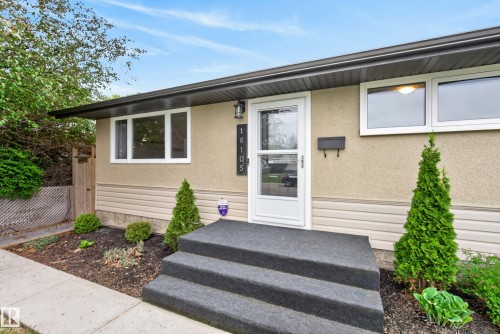 Inviting front exterior featuring a covered entryway, stucco facade, and horizontal siding accents - 16105 109A Avenue, Edmonton, AB 