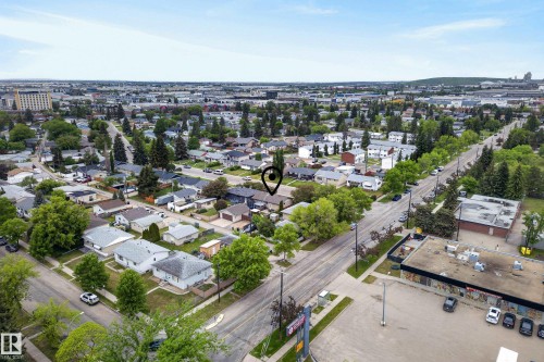 Aerial perspective showcasing a residential neighborhood with mature trees and a mixture of single-family homes and multi-unit dwellings - 16105 109A Avenue, Edmonton, AB 