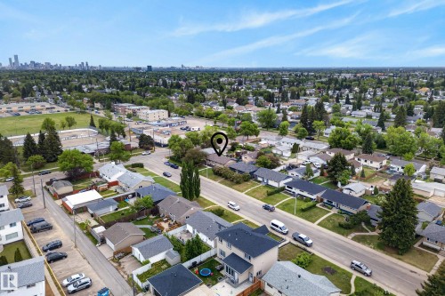 Established neighborhood featuring mature trees, residential properties, and a distant cityscape - 16105 109A Avenue, Edmonton, AB 