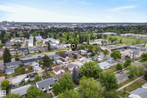 Residential neighborhood with mature tree coverage and visible commercial buildings - 16105 109A Avenue, Edmonton, AB 
