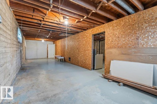 Expansive basement with concrete flooring and exposed wood ceiling joists - 12923 113A Street, Edmonton, AB 