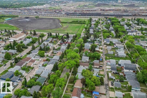 Residential neighborhood featuring mature tree-lined streets and individual properties with pitched roofs - 12923 113A Street, Edmonton, AB 