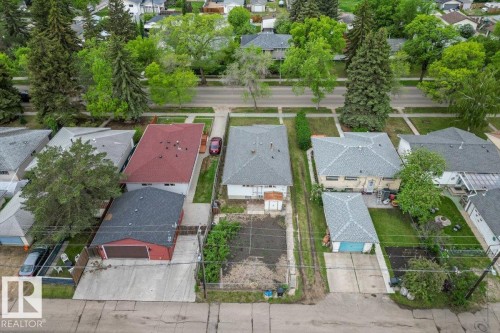 Expansive lot featuring a detached garage, a long driveway, a mature tree, and established perimeter fencing - 12923 113A Street, Edmonton, AB 