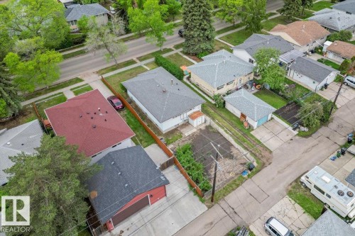Aerial perspective of a neighborhood featuring multiple residential properties with various roof styles and detached garages - 12923 113A Street, Edmonton, AB 
