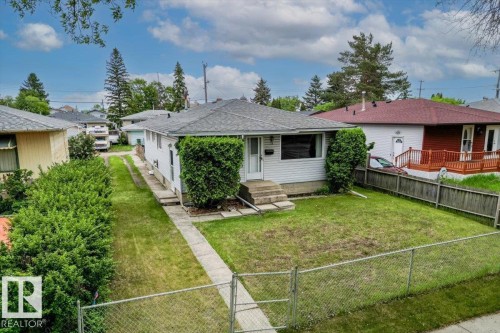 Single-story residence featuring a gray shingle roof and light-colored siding - 12923 113A Street, Edmonton, AB 