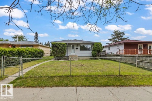 Ranch-style exterior with light-colored siding and a dark shingle roof - 12923 113A Street, Edmonton, AB 