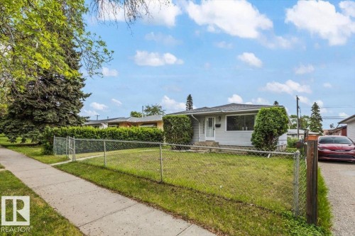 Single-story residence featuring white siding and a dark shingle roof - 12923 113A Street, Edmonton, AB 