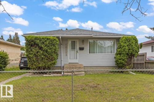 Single-story residence featuring light gray horizontal siding and a dark shingled roof - 12923 113A Street, Edmonton, AB 