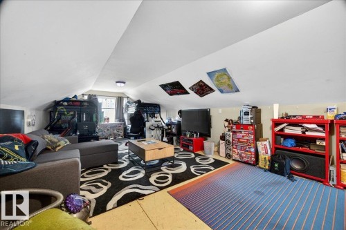 Spacious bonus room featuring sloped ceilings and a window - 572004 Highway 857, Rural Two Hills County, AB 