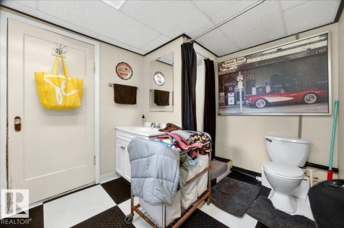 White vanity with a rectangular sink and chrome faucet - 572004 Highway 857, Rural Two Hills County, AB 