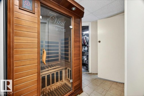 Built-in sauna with wood paneling and a clear glass door - 572004 Highway 857, Rural Two Hills County, AB 