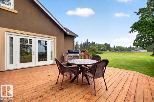 Expansive wood deck with a brown stucco exterior - 572004 Highway 857, Rural Two Hills County, AB 