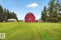 Red barn with white trim and a diamond window detail - 