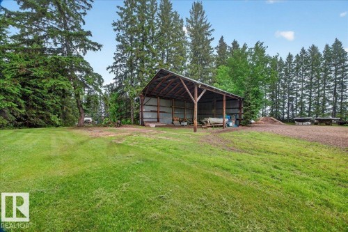Open-sided barn structure featuring a metal roof and wooden support beams - 572004 Highway 857, Rural Two Hills County, AB 