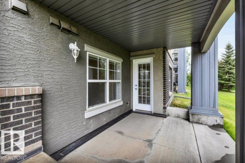 Covered patio with textured exterior siding - 116 630 Mcallister Loop, Edmonton, AB 