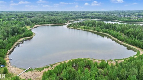 Expansive lake surrounded by mature trees - 337 Smith Crescent, Rural Parkland County, AB 