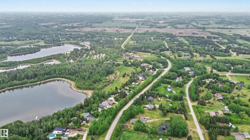 Aerial perspective showcasing a residential area bordered by two bodies of water - 337 Smith Crescent, Rural Parkland County, AB 