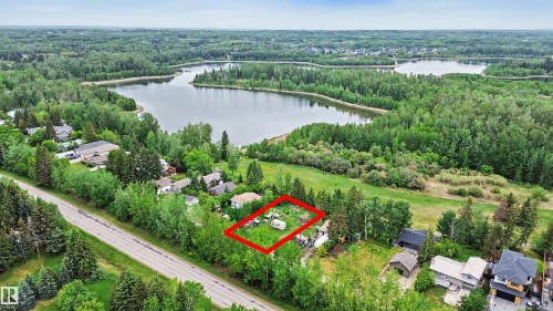 Expansive undeveloped lot with existing recreational vehicles, positioned among mature trees - 337 Smith Crescent, Rural Parkland County, AB 