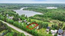 Expansive undeveloped lot with existing recreational vehicles, positioned among mature trees - 337 Smith Crescent, Rural Parkland County, AB 