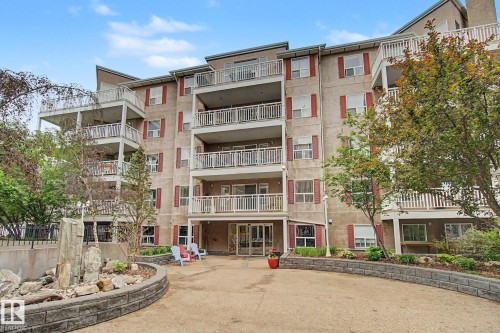 Multi-story residential building featuring private balconies with white railings - 308 10933 124 Street, Edmonton, AB 