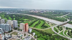 Expansive urban landscape featuring high-rise buildings, a river, and multiple bridges - 