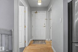 Entryway featuring wood-finish flooring, light grey walls, and a recessed ceiling light fixture - 