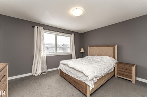 Neutral-toned wall paint and grey carpeting create a cohesive aesthetic - 115 57 Street, Edmonton, AB 
