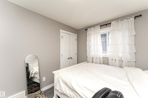Bedroom featuring light gray wall paint and wood-finish flooring - 115 57 Street, Edmonton, AB 