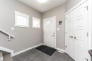 Entryway featuring grey tile flooring, white paneled doors, and a full-light entry door - 115 57 Street, Edmonton, AB 
