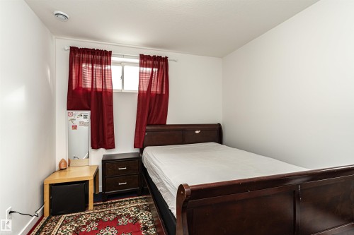 Window with natural light, finished walls, and a ceiling-mounted smoke detector - 115 57 Street, Edmonton, AB 