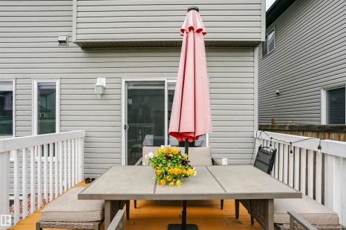 Spacious outdoor deck featuring light wood-finish flooring and white railing - 115 57 Street, Edmonton, AB 