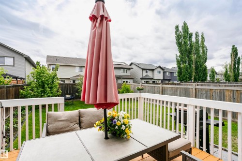 Expansive wooden deck featuring white railings and a spacious patio area - 115 57 Street, Edmonton, AB 