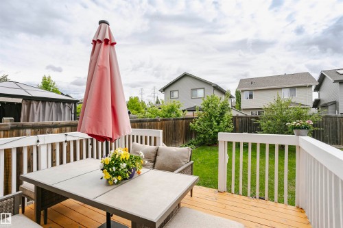 Wood-finish deck with white railing, featuring a covered pergola structure - 115 57 Street, Edmonton, AB 