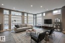 Expansive living area featuring multiple large windows, wood-finish flooring, recessed lighting, and neutral wall tones - 401 10238 103 Street, Edmonton, AB  - Indoor Photo Showing Living Room 