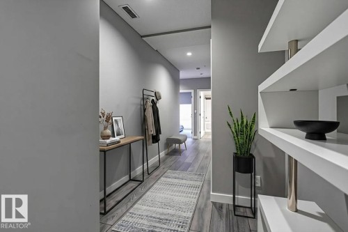 Hallway featuring wood-finish flooring, recessed lighting, and built-in shelving - 401 10238 103 Street, Edmonton, AB - Indoor Photo Showing Other Room