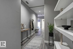 Hallway featuring wood-finish flooring, recessed lighting, and built-in shelving - 