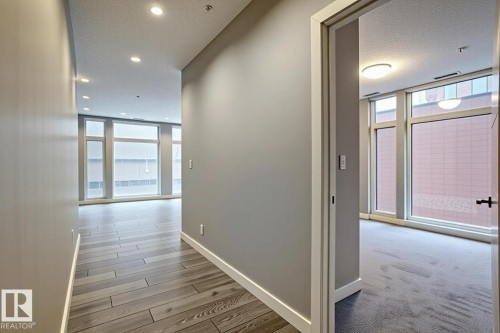 Hallway featuring wood-finish flooring, recessed lighting, and a neutral wall palette - 401 10238 103 Street, Edmonton, AB - Indoor Photo Showing Other Room