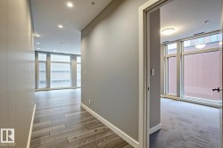 Hallway featuring wood-finish flooring, recessed lighting, and a neutral wall palette - 